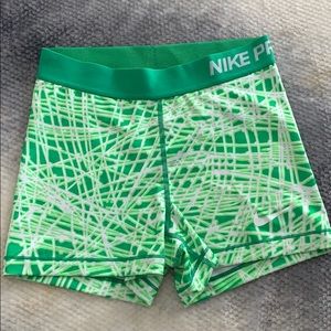 Green and white Nike Pro shorts